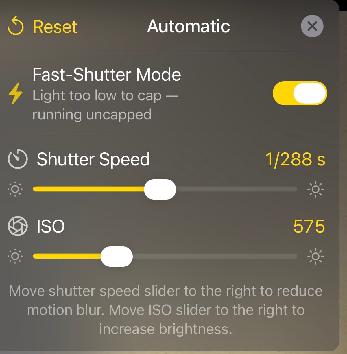 The MotionEdge exposure card on iPhone: Fast-Shutter Mode toggled on and reporting "light too low to cap — running uncapped", a Shutter Speed slider reading 1/288 s, and an ISO slider reading 575, above a hint explaining that moving shutter speed right reduces motion blur and moving ISO right increases brightness
