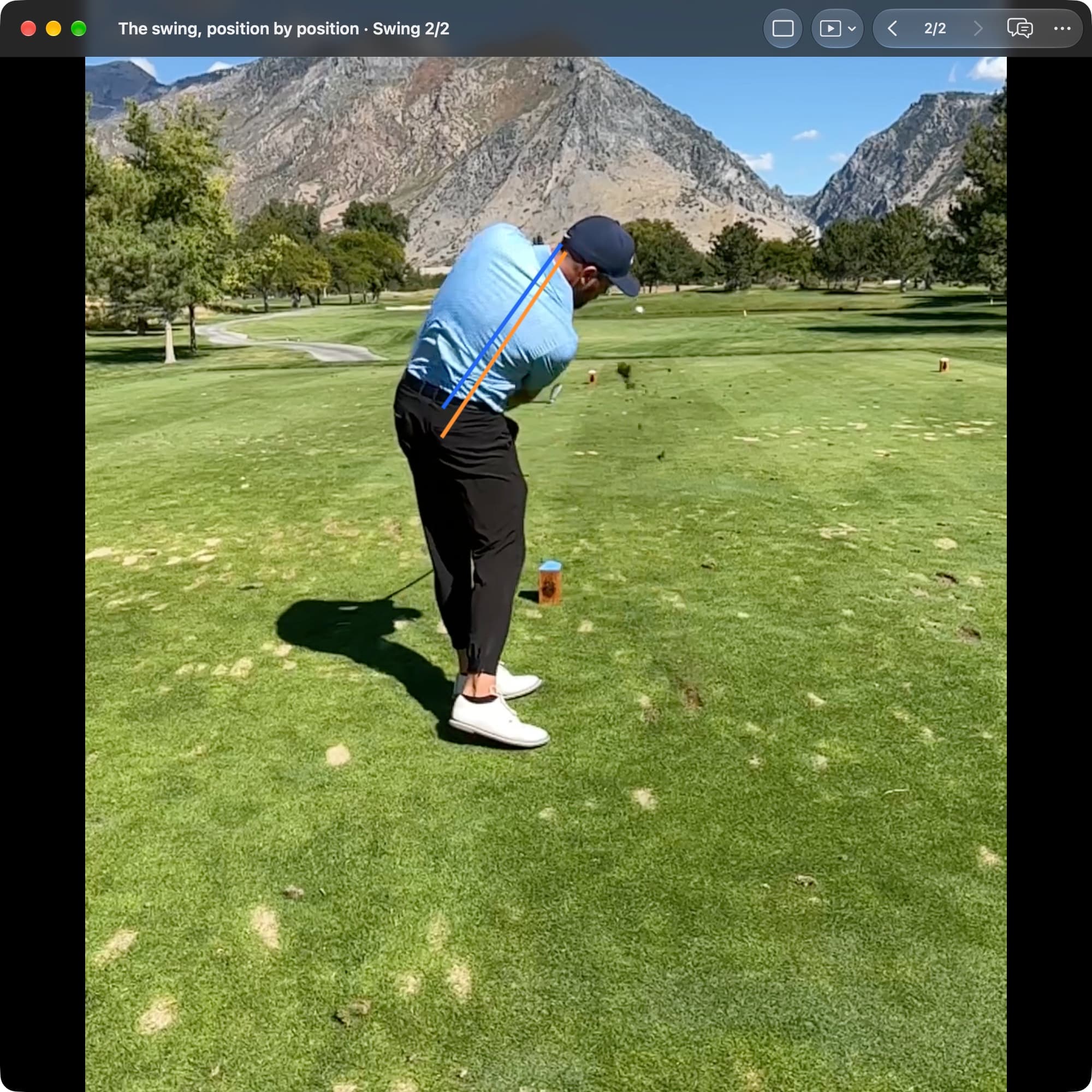 A golfer in MotionEdge Video Player, down-the-line on a course, in the follow-through. An orange line shows the torso angle at Address and a blue line shows it now, more upright.