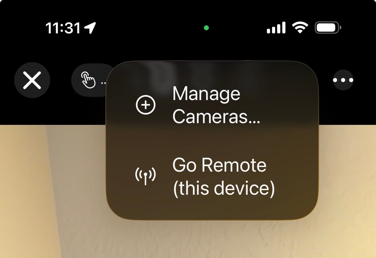 The MotionEdge camera menu on iPhone offering two choices: "Manage Cameras…" and "Go Remote (this device)"