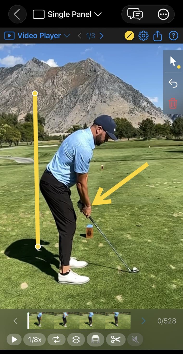 The Video Player panel in MotionEdge Swing Review with drawing switched on: a yellow vertical line dropped from the golfer's head to the ground and a yellow arrow pointing at the hands at address, with the drawing tool strip open on the right showing select, undo and delete