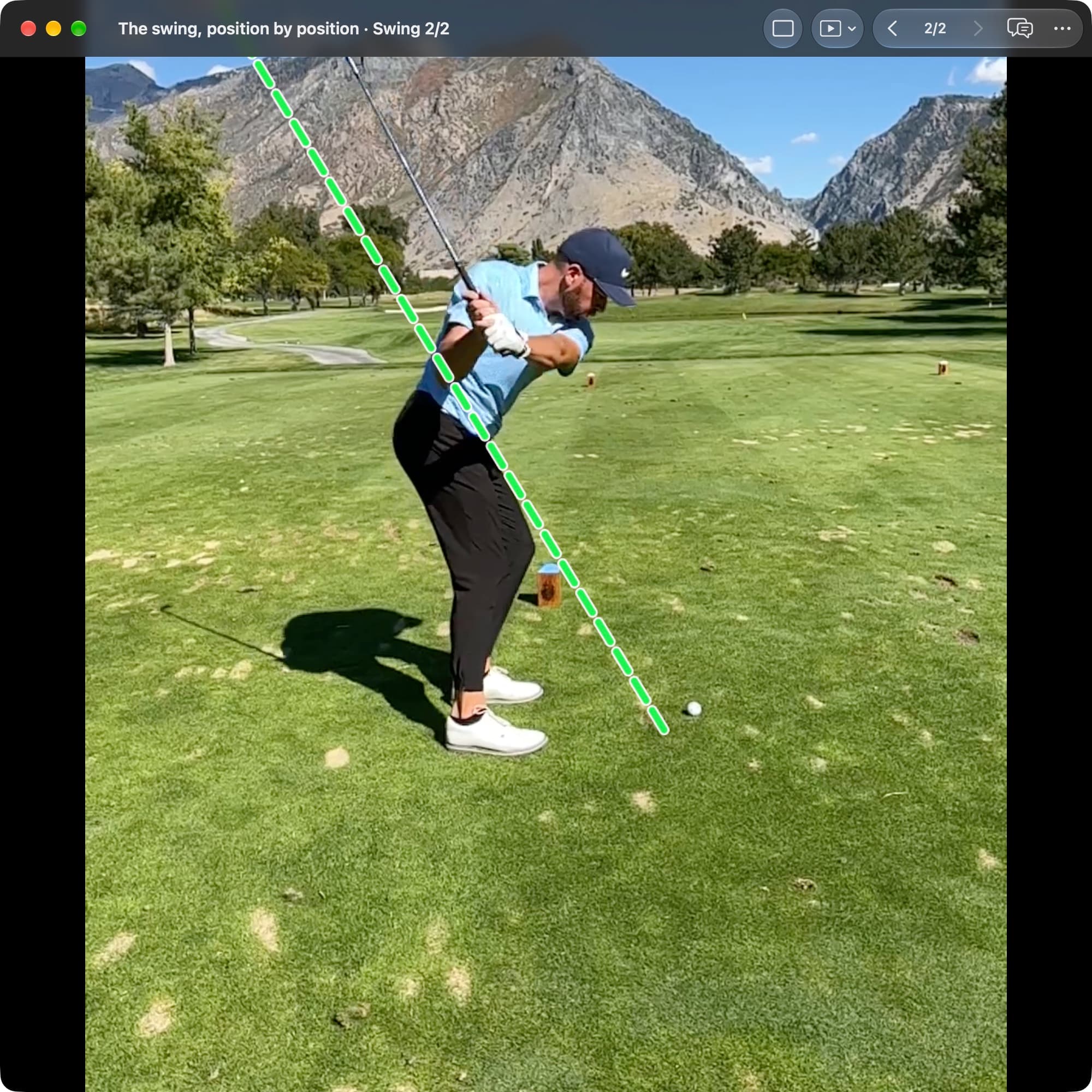 A golfer in MotionEdge Video Player, down-the-line on a course, in the downswing. A dashed green line shows the shaft angle from Address; the club is returning on or just under it.