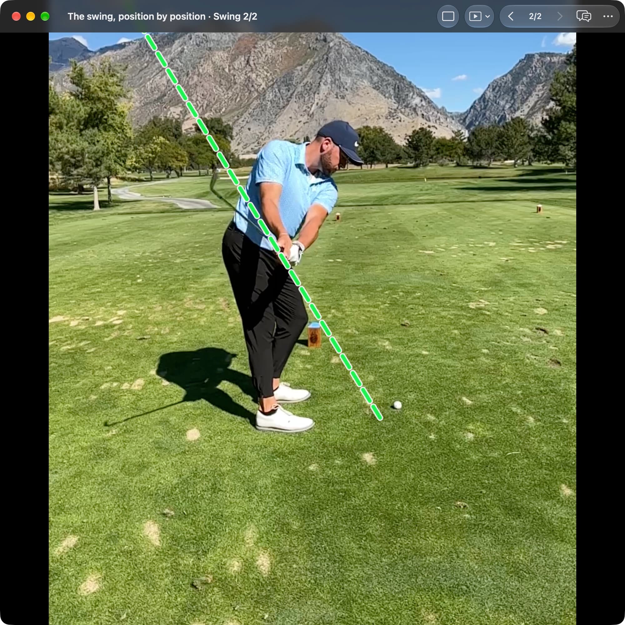A golfer in MotionEdge Video Player, down-the-line on a course, early in the takeaway. A dashed green line runs from the ball up along the shaft angle set at Address; the club has moved back and slightly inside it.